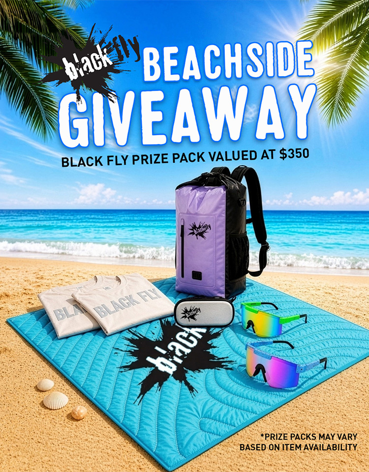 Black Fly Beachside Giveaway promotional image featuring image of prize package on the beach